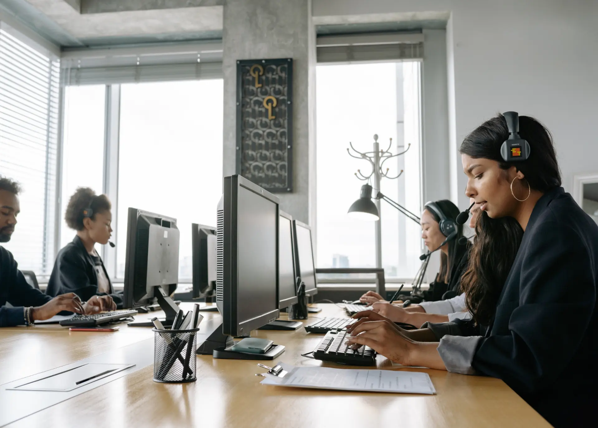 Support team working at monitors in an open office